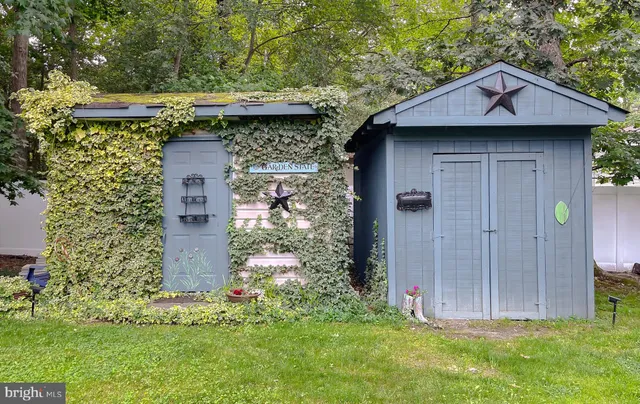 a view of a swimming pool with a yard and trees in the background