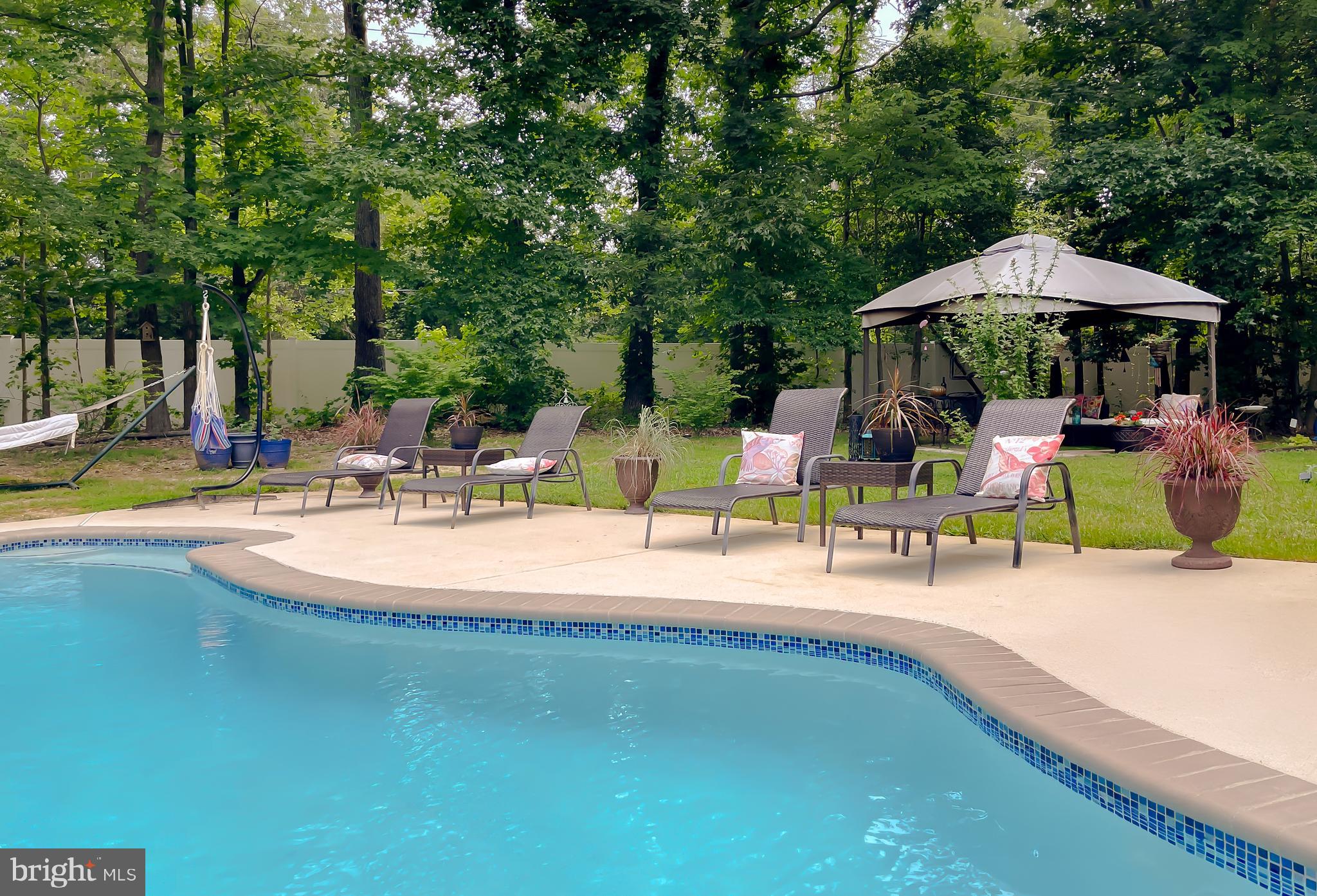 22338 White Oak Road Leonardtown, MD 20650 - Photo 62 of 66 a view of a swimming pool with an outdoor seating