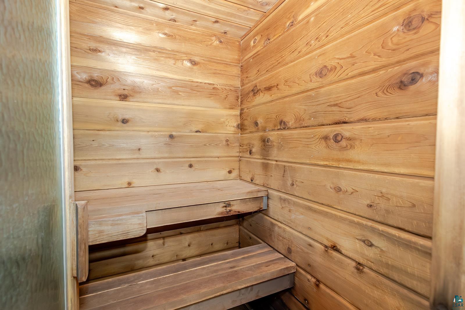 29 Ridge Road Esko, MN 55733 - Photo 32 of 41 Cedar-paneled interior featuring built-in wooden benches
