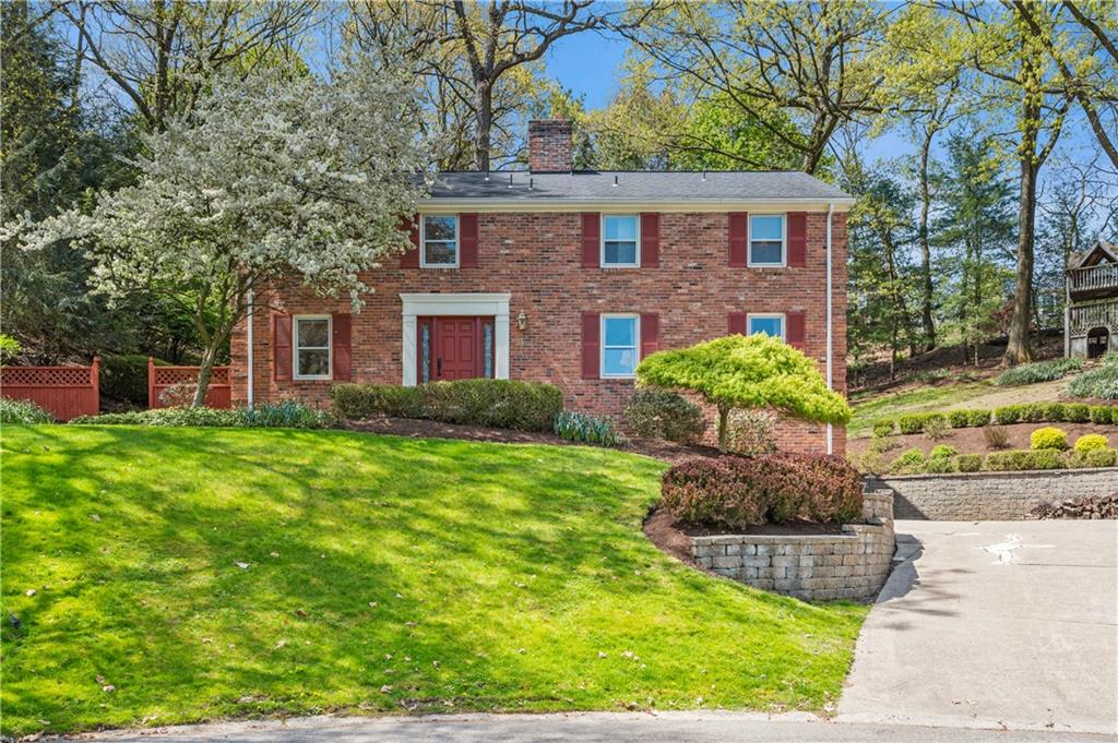 a front view of a house with a garden