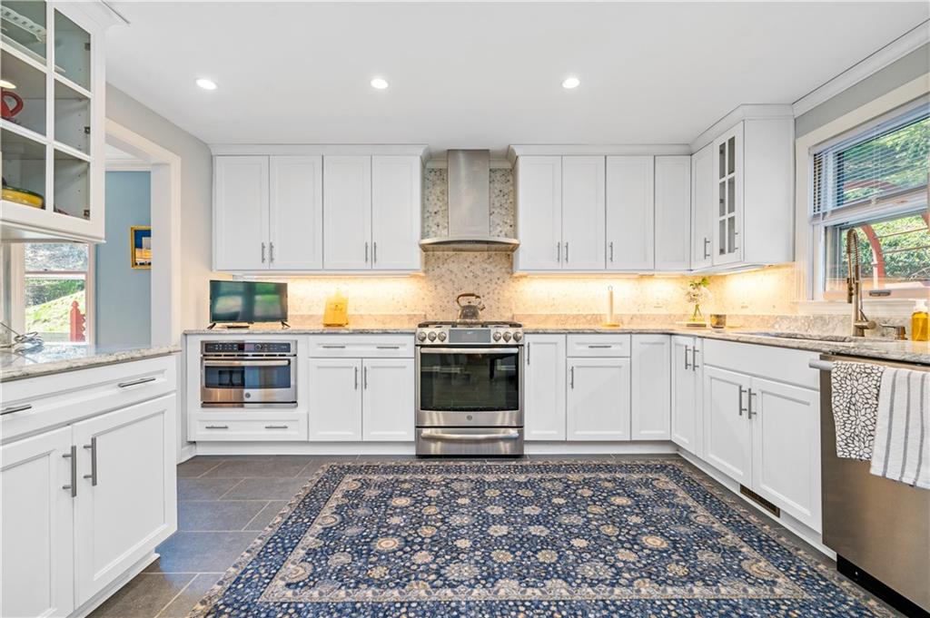 104 Ascot Place Pittsburgh, PA 15237 - Photo 3 of 26 a kitchen with stainless steel appliances granite countertop a stove a sink and a refrigerator