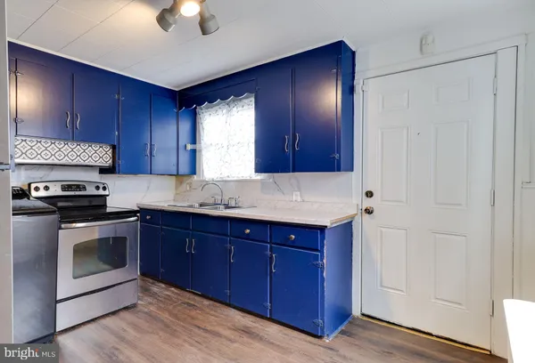 a kitchen with granite countertop wooden cabinets and stainless steel appliances