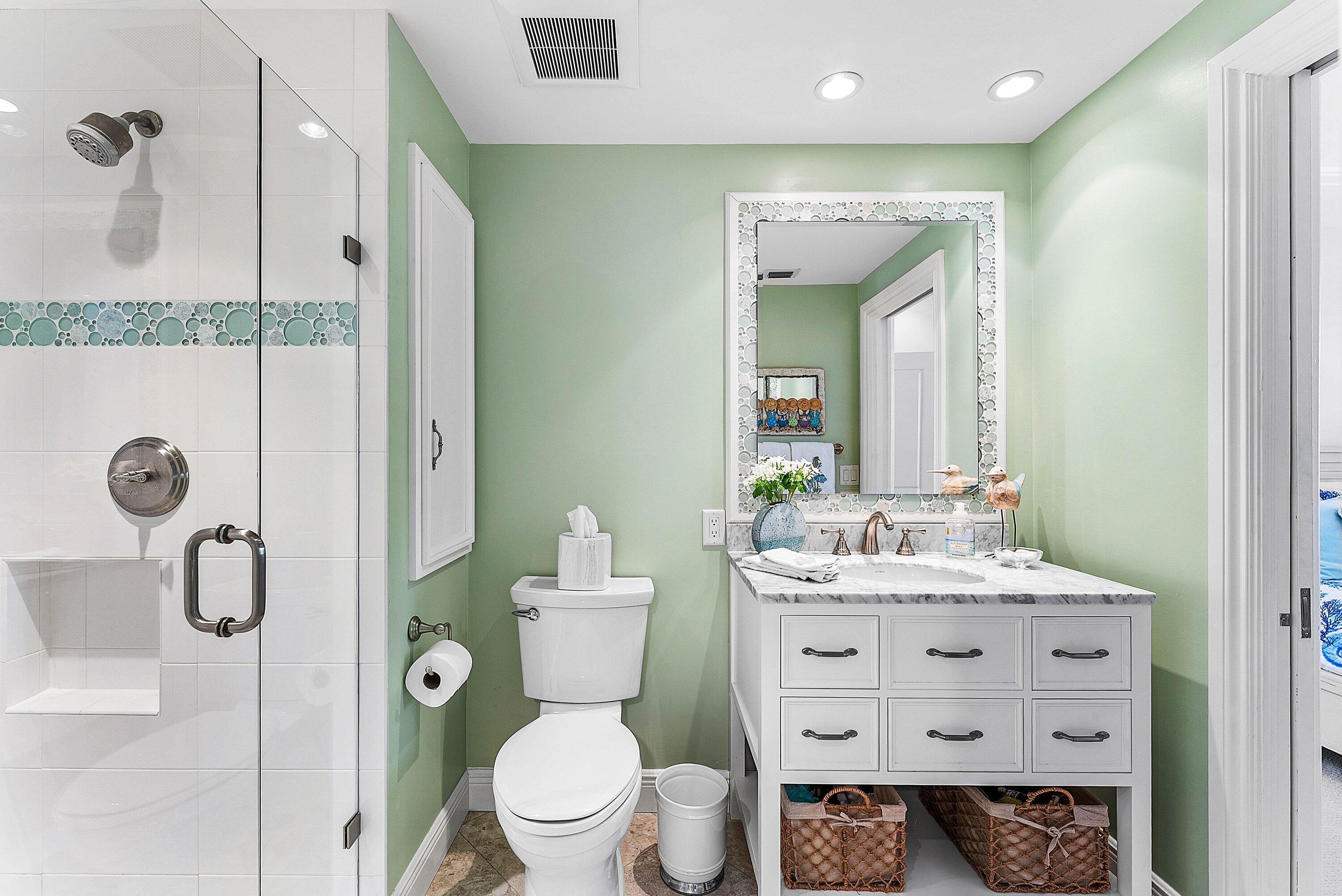 2103 South Ocean Boulevard, Unit 4B Delray Beach, FL 33483 - Photo 18 of 46 a bathroom with a toilet sink vanity granite and shower
