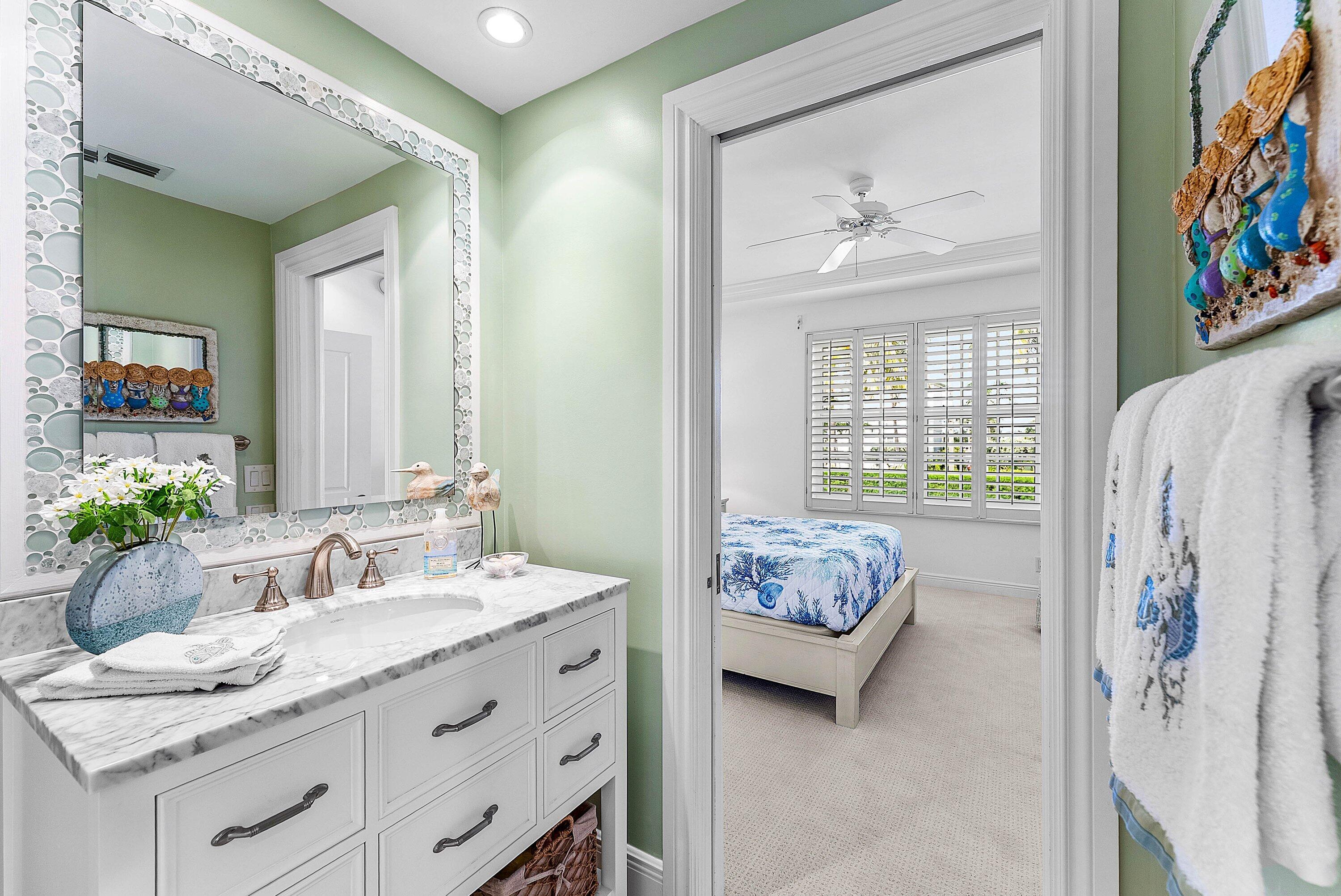 2103 South Ocean Boulevard, Unit 4B Delray Beach, FL 33483 - Photo 19 of 46 a en suite bathroom with a granite countertop tub and a window