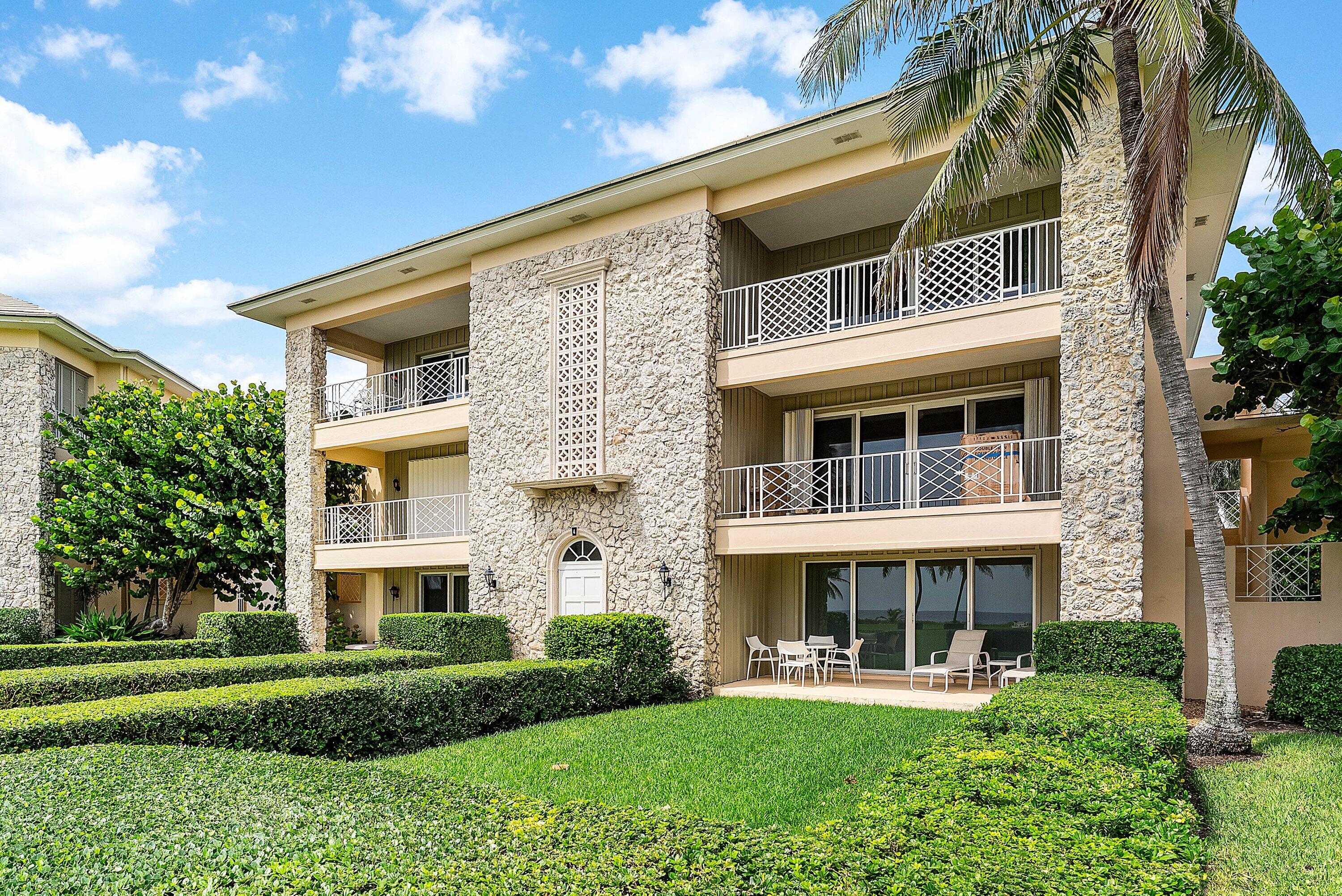 2103 South Ocean Boulevard, Unit 4B Delray Beach, FL 33483 - Photo 31 of 46 a front view of a house with a yard table and chairs