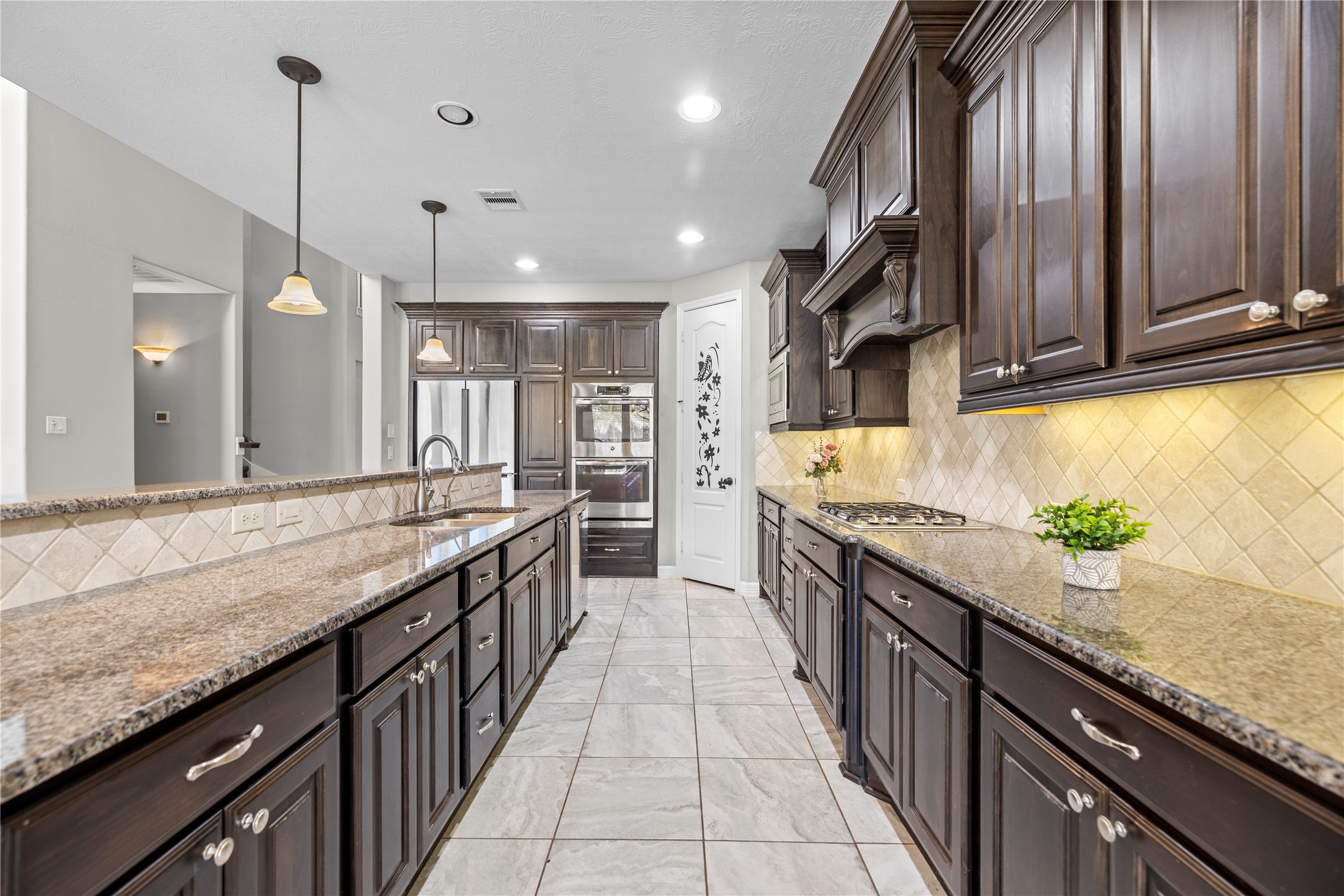 27506 Windcrest Key Lane Fulshear, TX 77441 - Photo 14 of 30 a large kitchen with granite countertop a sink and a stove
