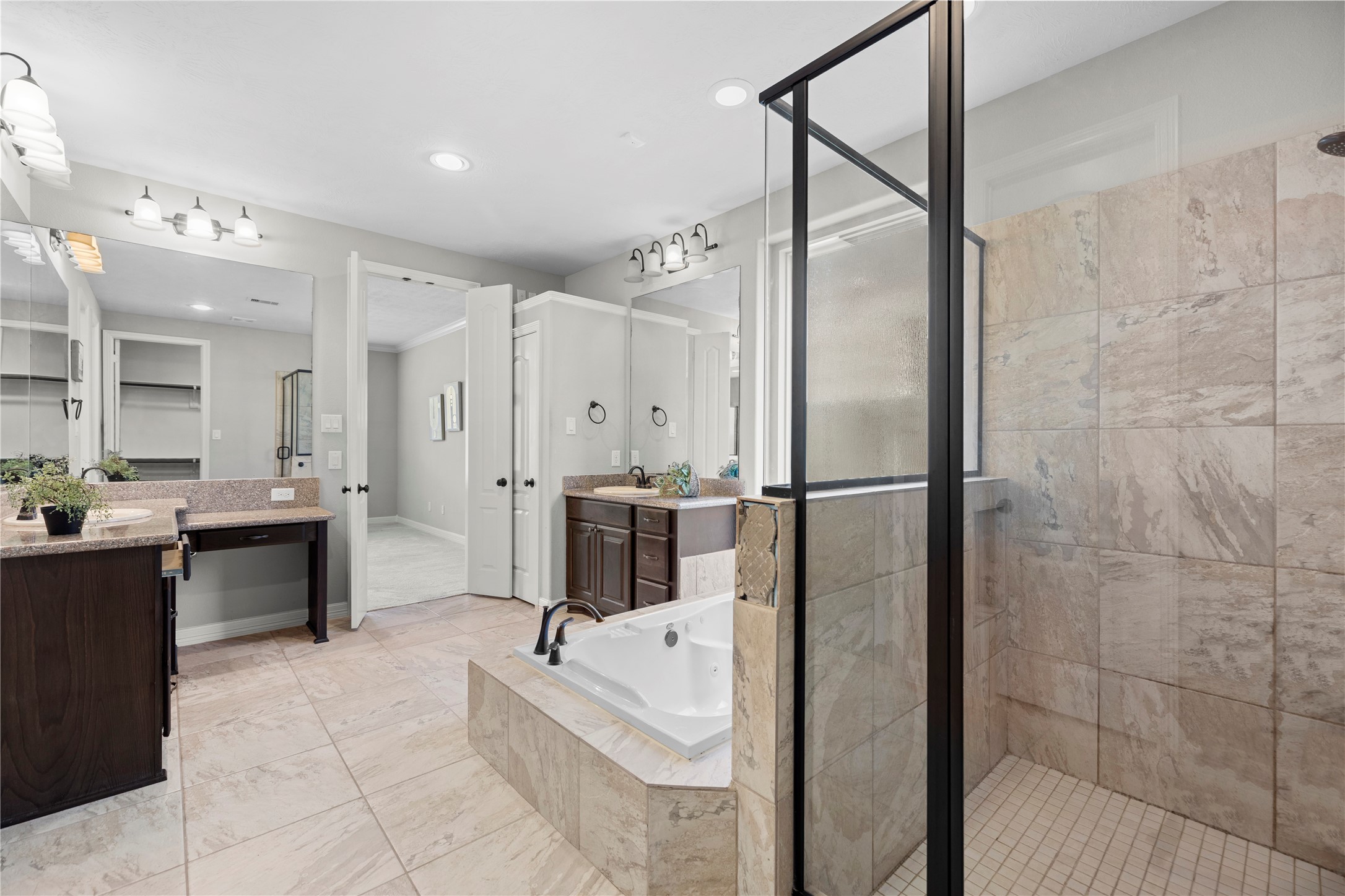 27506 Windcrest Key Lane Fulshear, TX 77441 - Photo 19 of 30 a bathroom with a tub a sink a mirror and a shower