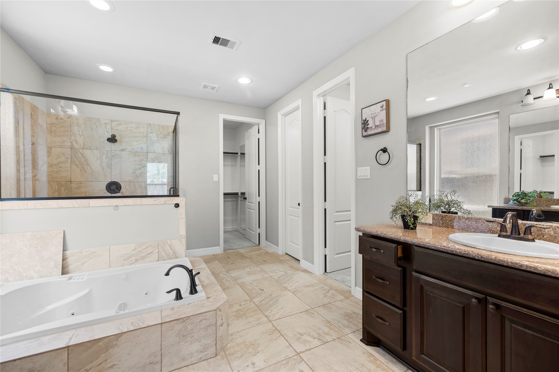 27506 Windcrest Key Lane Fulshear, TX 77441 - Photo 20 of 30 a bathroom with a tub sink double and mirror