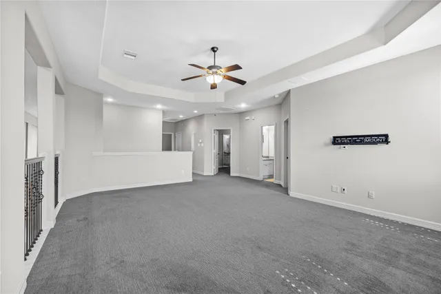 an empty room with a empty space and a ceiling fan