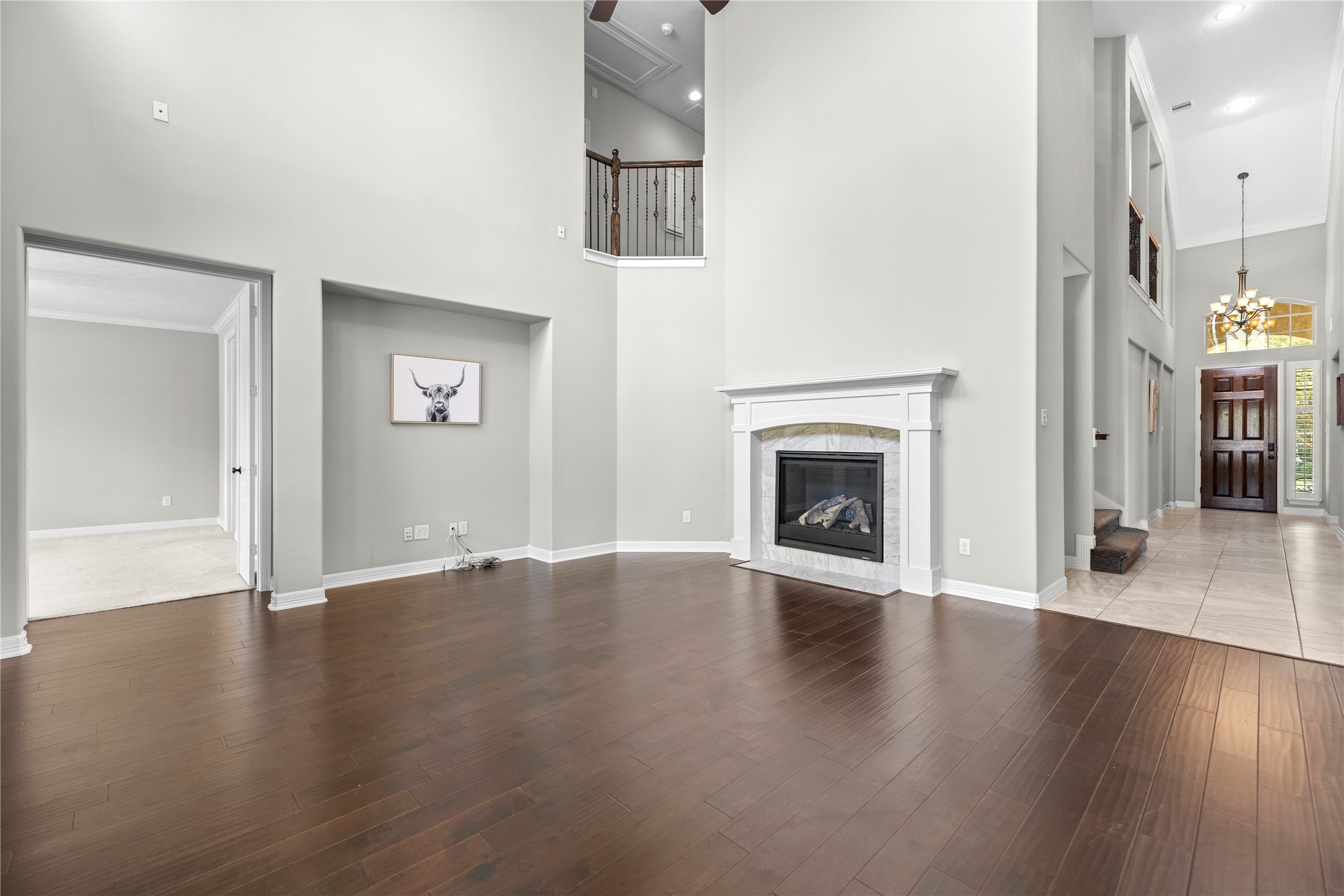 27506 Windcrest Key Lane Fulshear, TX 77441 - Photo 8 of 30 an empty room with wooden floor fireplace and windows
