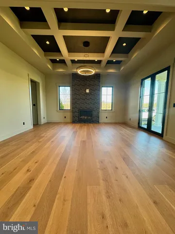 a view of hallway with stairs and wooden floor