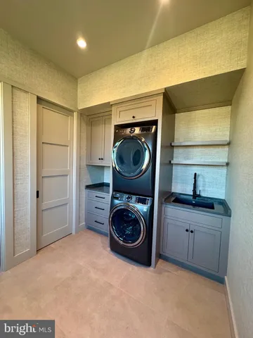 a utility room with sink dryer and washer