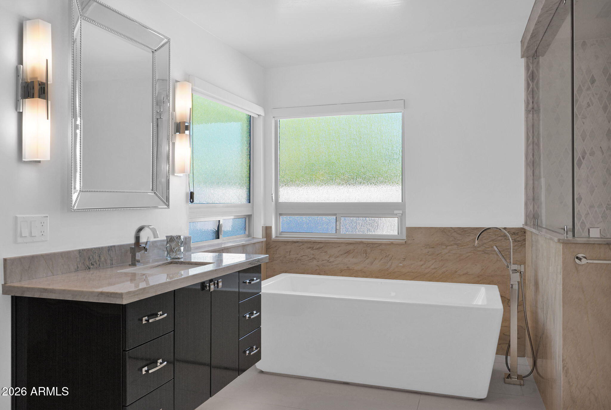 11813 North Blackheath Road Scottsdale, AZ 85254 - Photo 23 of 55 a bathroom with a tub a sink and a mirror