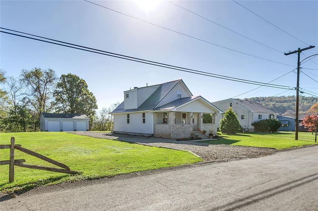 224 Trailer Boulevard Lower Burrell, PA 15068 - Photo 2 of 24 a view of a big house with a big yard and palm trees