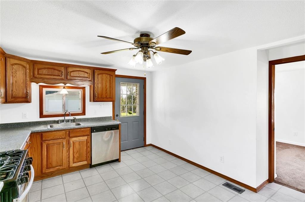 224 Trailer Boulevard Lower Burrell, PA 15068 - Photo 13 of 24 a kitchen with a stove a sink and a refrigerator