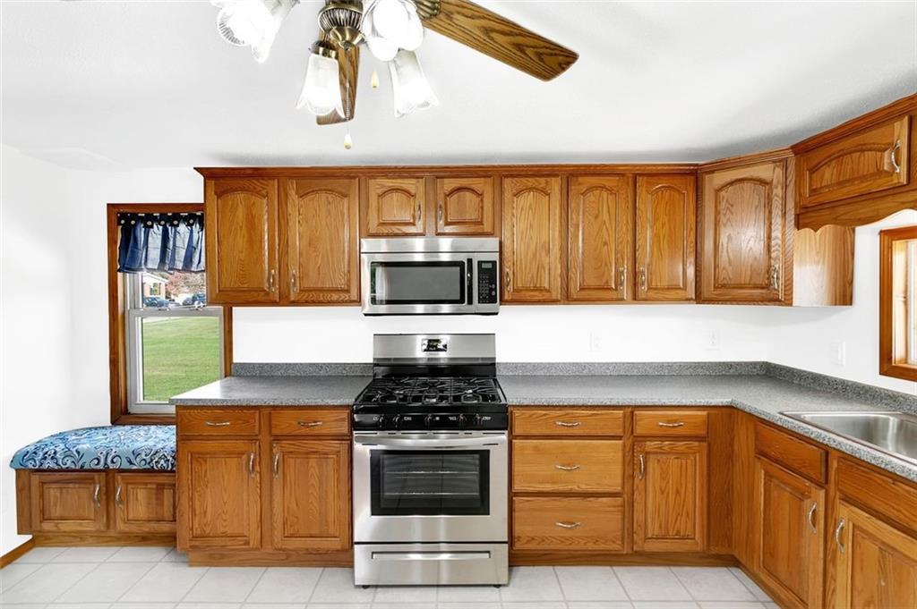 224 Trailer Boulevard Lower Burrell, PA 15068 - Photo 14 of 24 a kitchen with granite countertop a stove and cabinets