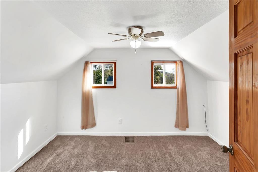 224 Trailer Boulevard Lower Burrell, PA 15068 - Photo 18 of 24 an empty room with windows and fan