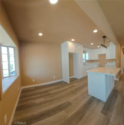 a view of kitchen and kitchen with furniture wooden floor and window