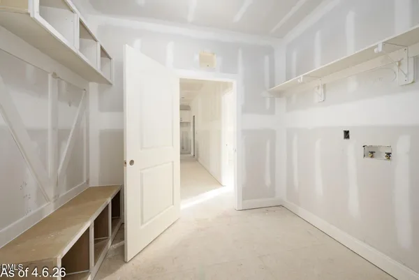 a living room with stainless steel appliances kitchen island granite countertop a refrigerator and cabinets