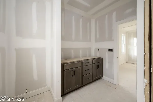 a view of a kitchen with white cabinets