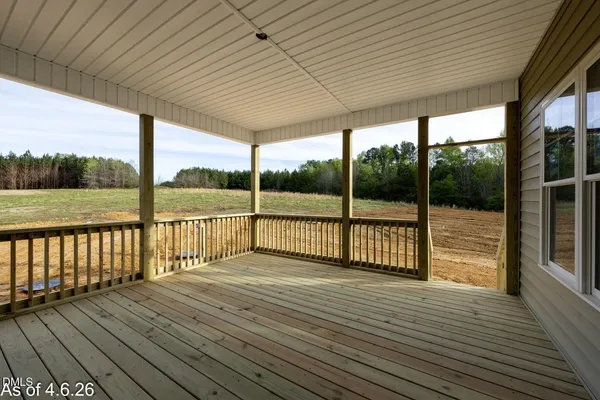 a view of deck with wooden floor and floor to ceiling window