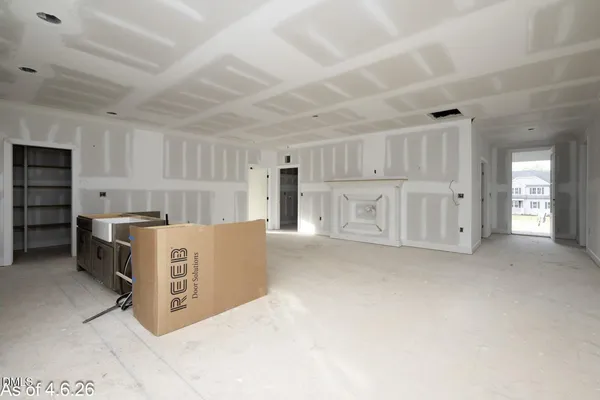 a large white kitchen with a large window