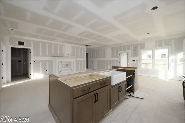 a kitchen with stainless steel appliances a stove a refrigerator a sink and white cabinets