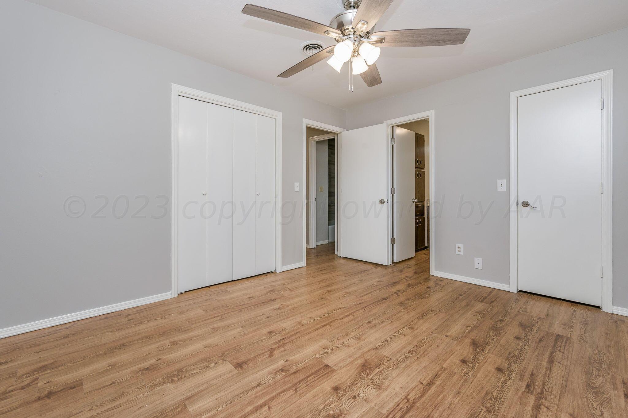 6705 Brandon Lane Amarillo, TX 79109 - Photo 11 of 20 a view of an empty room with wooden floor