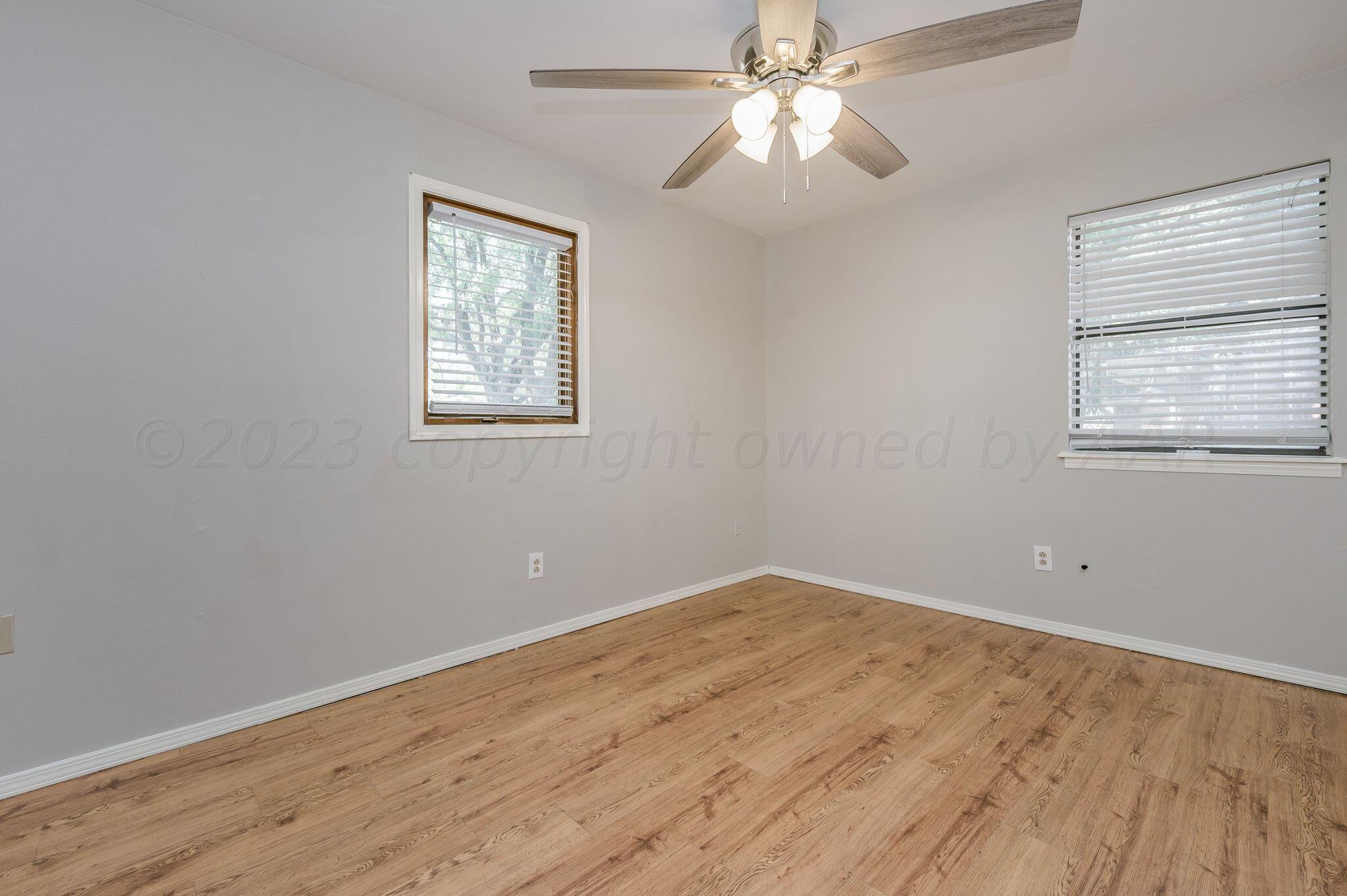 6705 Brandon Lane Amarillo, TX 79109 - Photo 13 of 20 a view of empty room with wooden floor and fan
