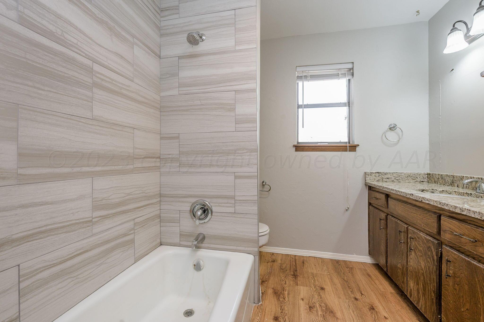 6705 Brandon Lane Amarillo, TX 79109 - Photo 14 of 20 a bathroom with a bathtub and shower