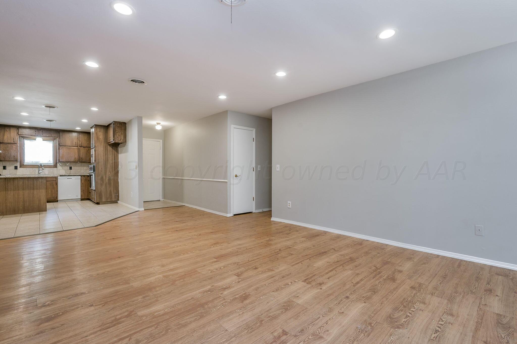 6705 Brandon Lane Amarillo, TX 79109 - Photo 5 of 20 a view of an empty room with a kitchen