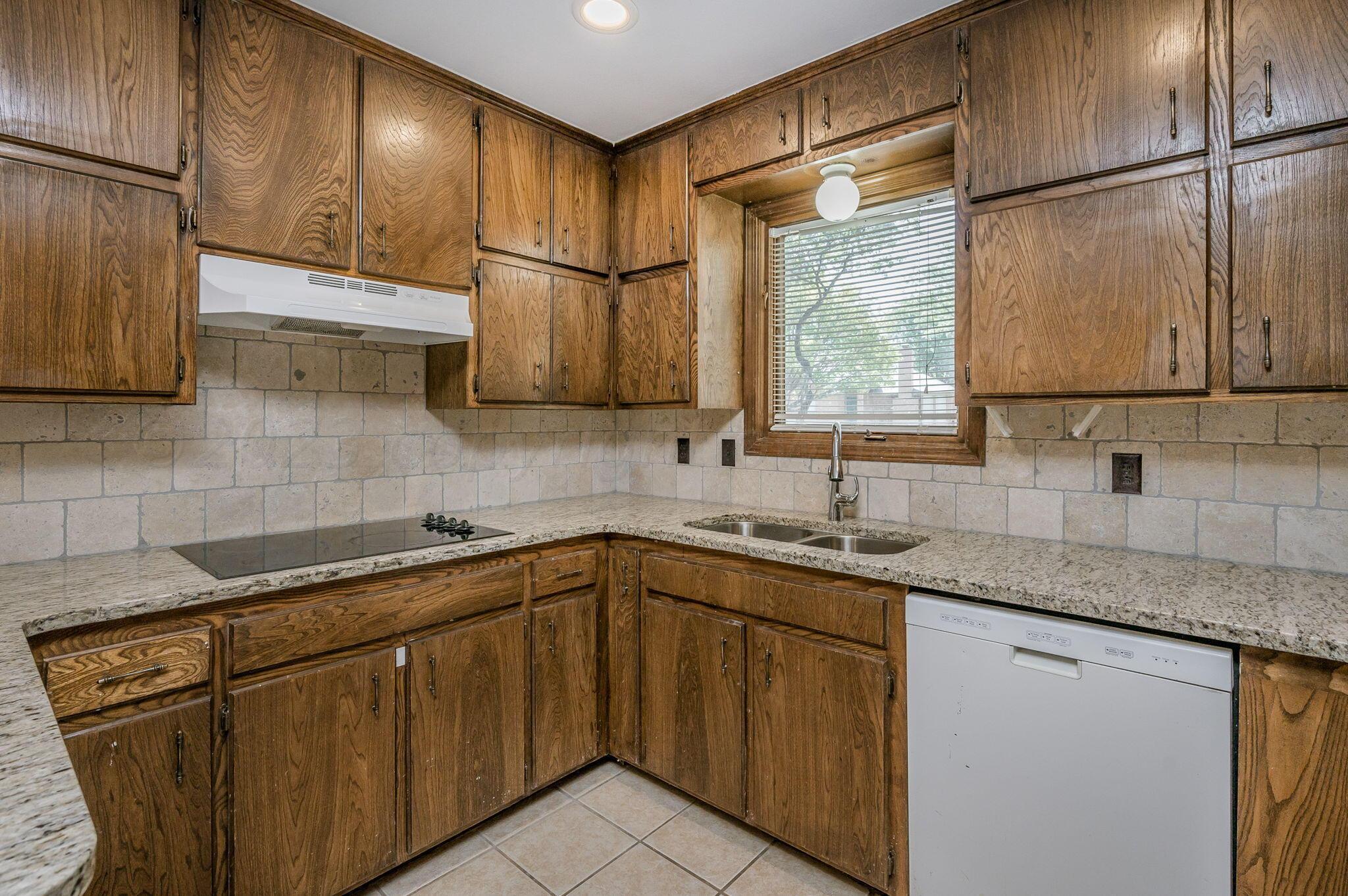 6705 Brandon Lane Amarillo, TX 79109 - Photo 7 of 20 a kitchen with stainless steel appliances granite countertop a sink stove and refrigerator