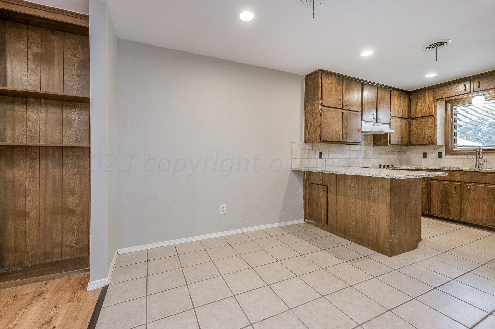 6705 Brandon Lane Amarillo, TX 79109 - Photo 9 of 20 a kitchen with stainless steel appliances a sink stove and cabinets