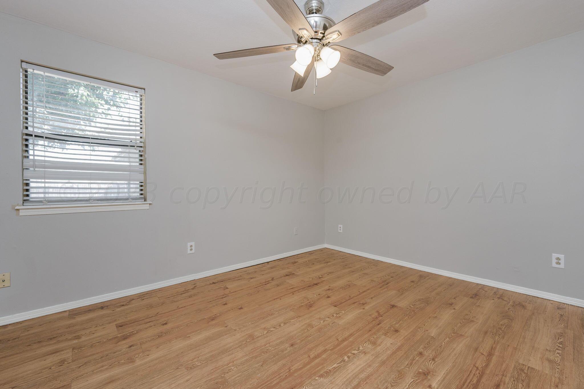 6705 Brandon Lane Amarillo, TX 79109 - Photo 10 of 20 a view of empty room with wooden floor and fan