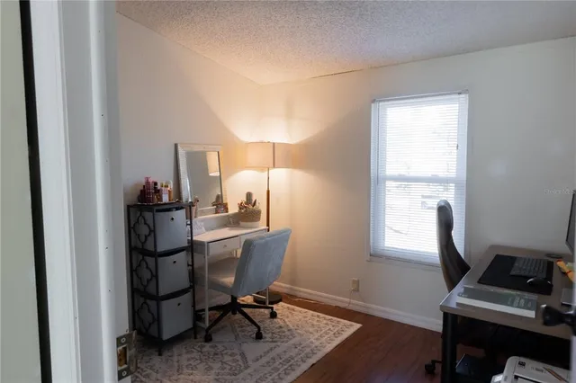 a view of a workspace with furniture and a window