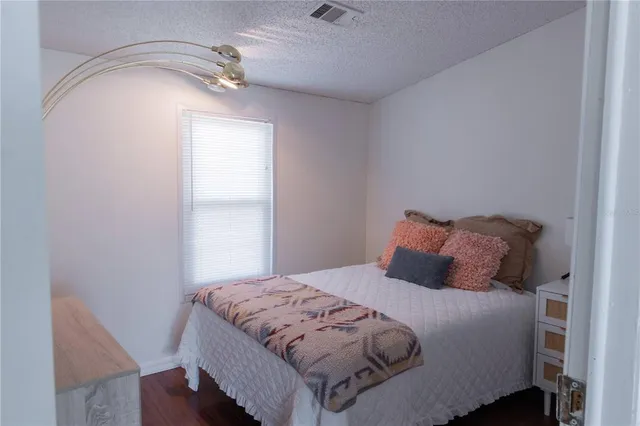 a bedroom with a bed and a dresser in it