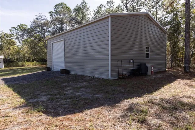 a view of a backyard with table and chairs