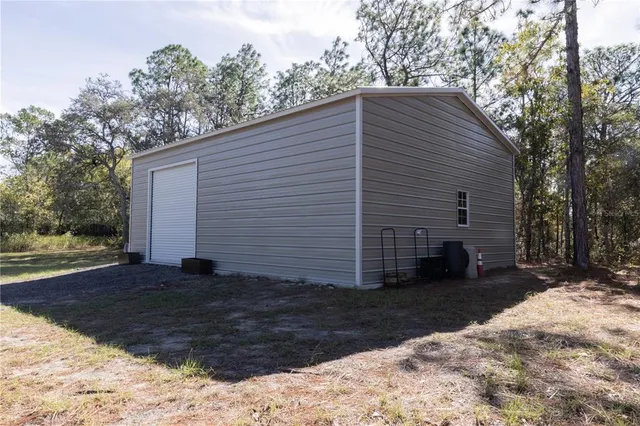 a view of a house with backyard and trees