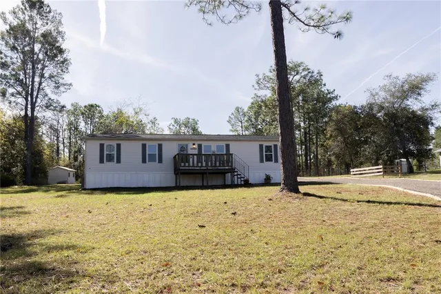 a view of a backyard with trees