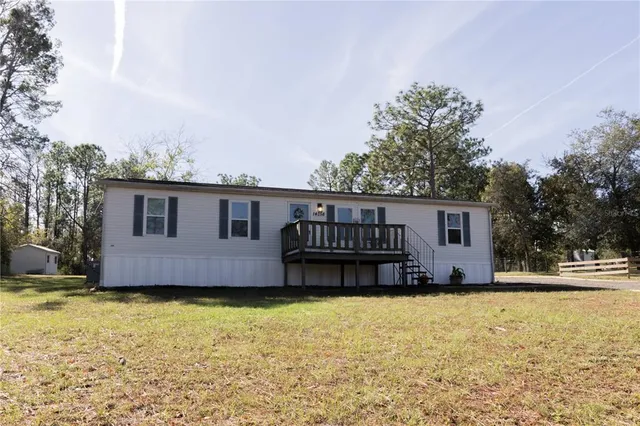 a view of a house with a backyard