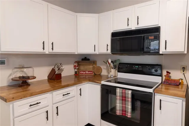 a kitchen with cabinets appliances and a sink