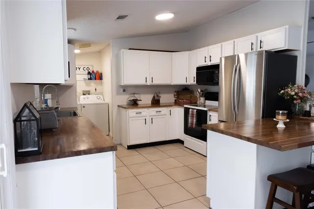 a kitchen with stainless steel appliances a refrigerator sink stove microwave and cabinets