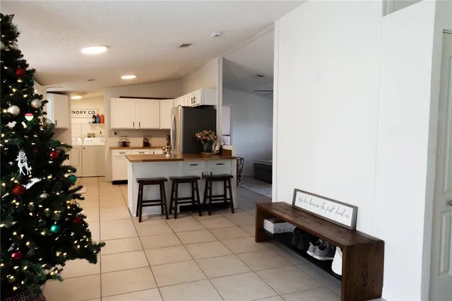 a view of kitchen with kitchen island stainless steel appliances a sink and cabinets