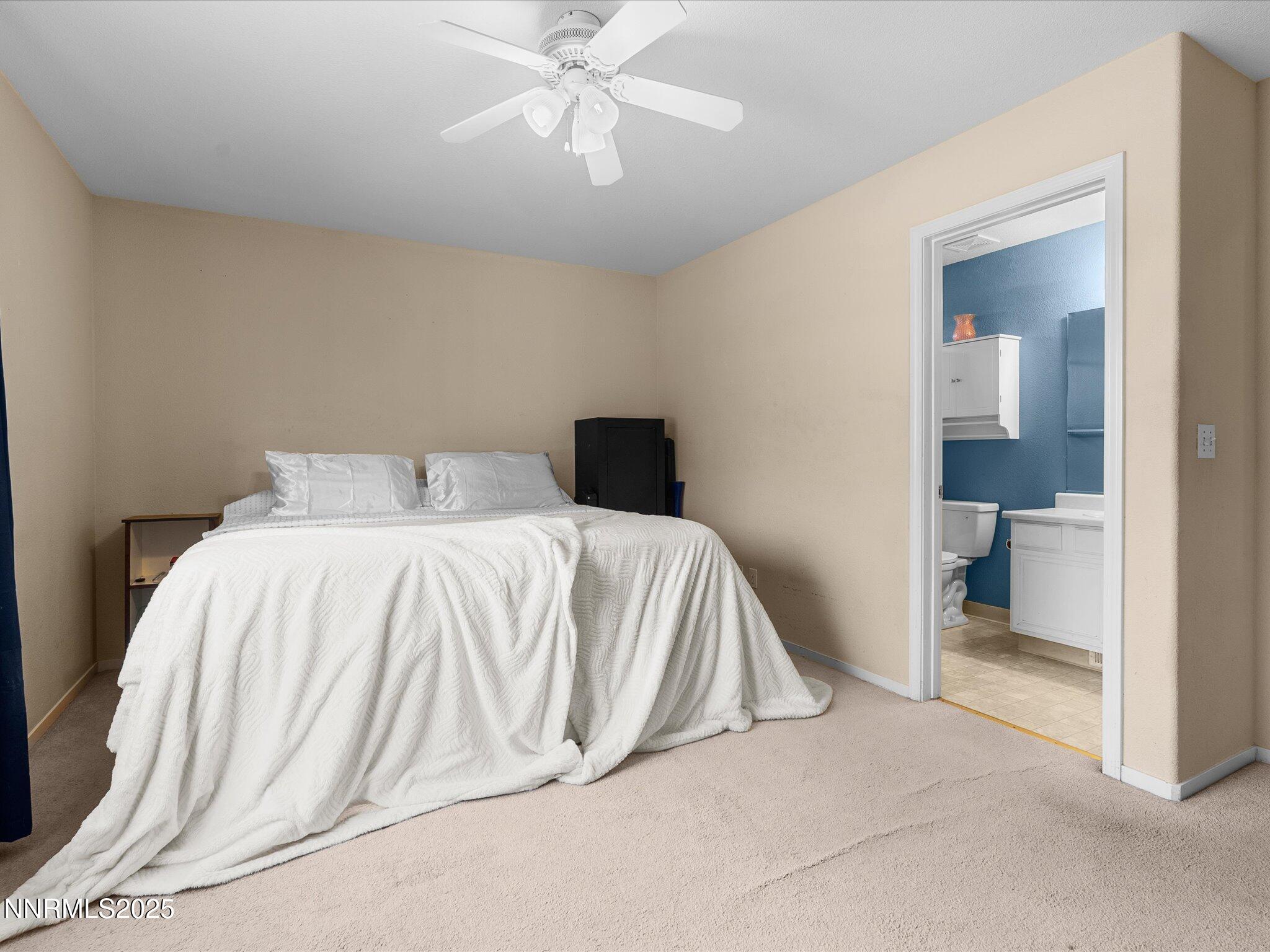 17795 Georgetown Drive Reno, NV 89508 - Photo 12 of 41 a bedroom with a bed and a chandelier