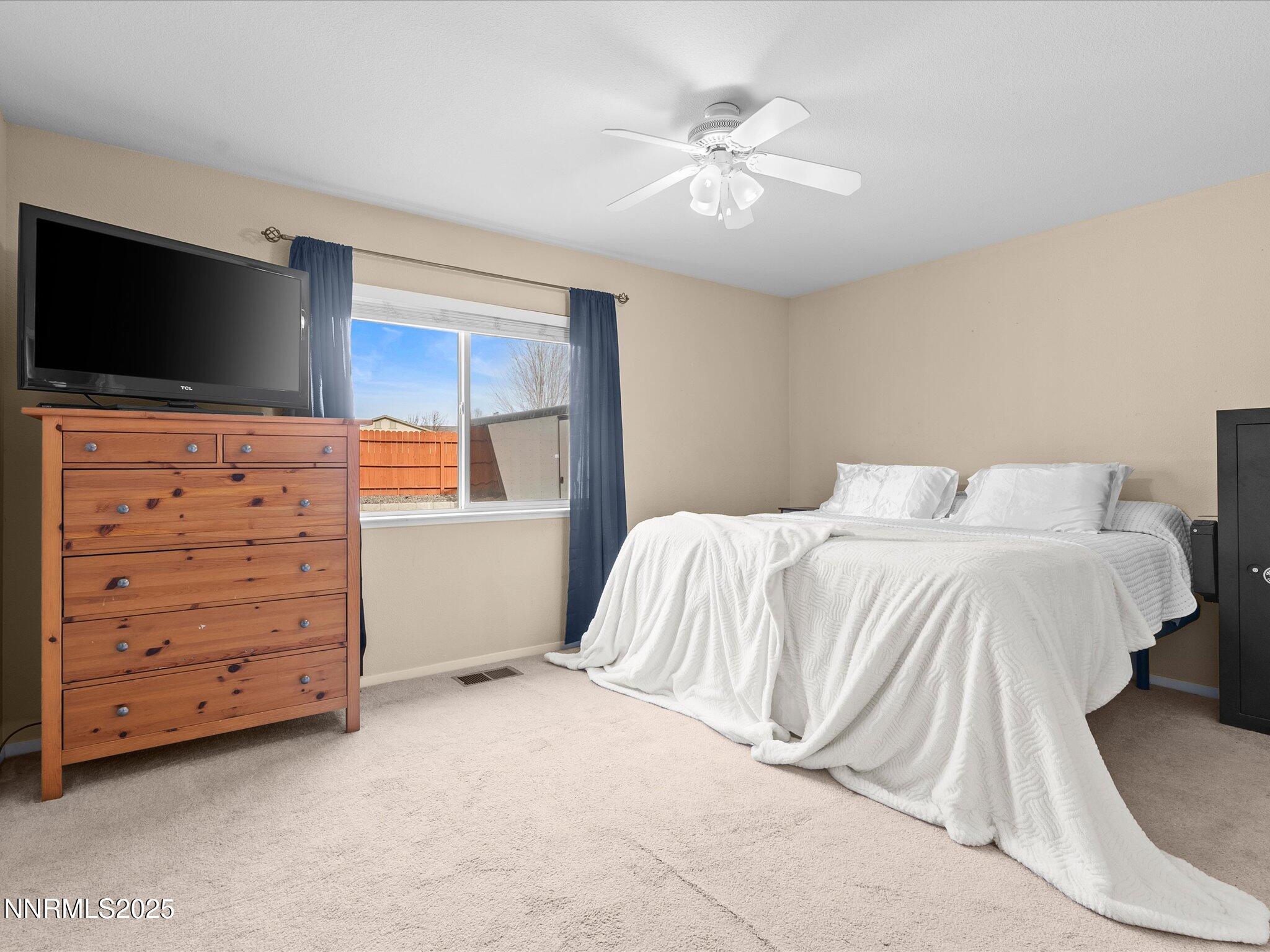 17795 Georgetown Drive Reno, NV 89508 - Photo 13 of 41 a bedroom with a bed and a flat screen tv