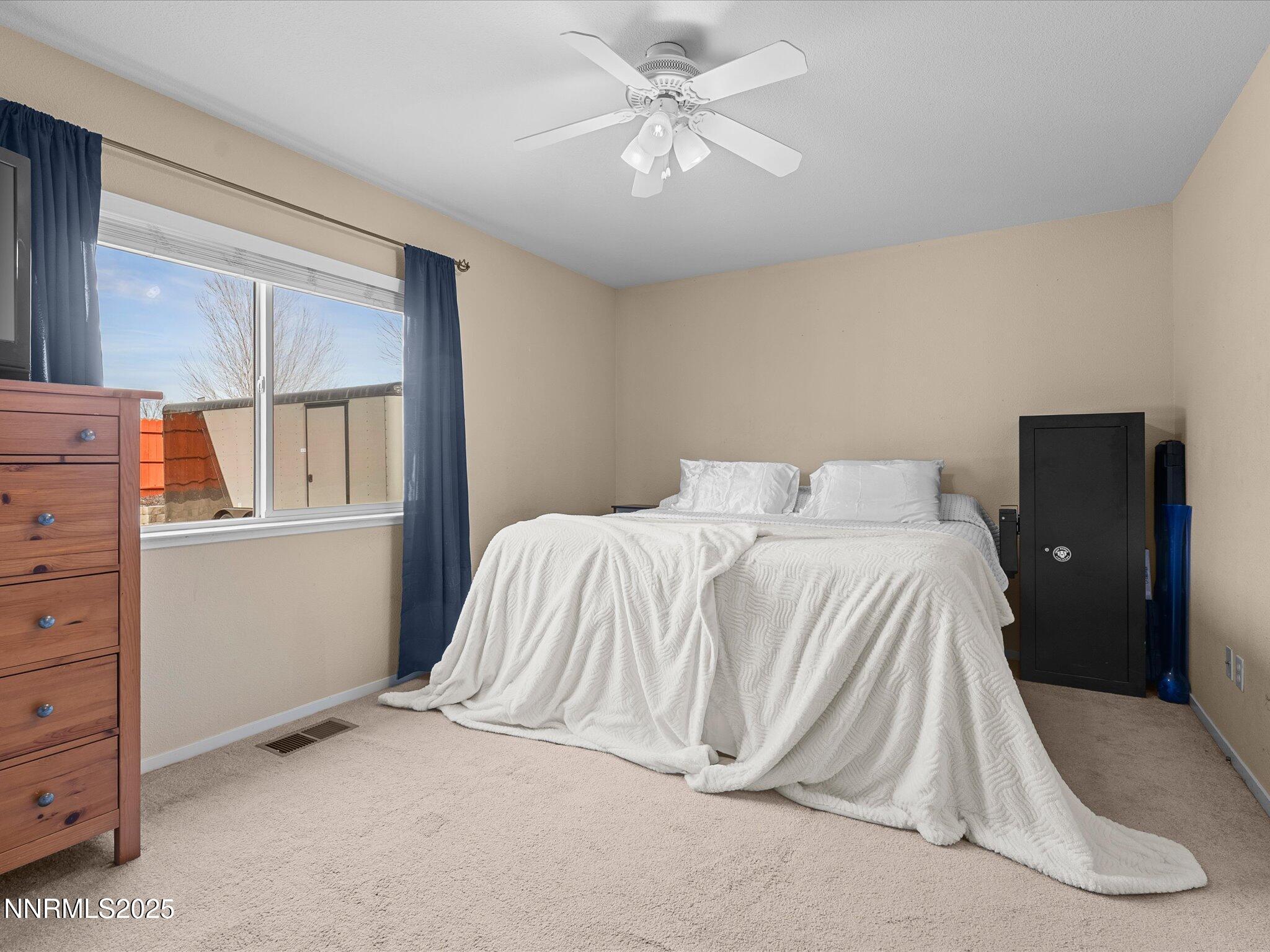17795 Georgetown Drive Reno, NV 89508 - Photo 14 of 41 a bedroom with a bed and a chandelier