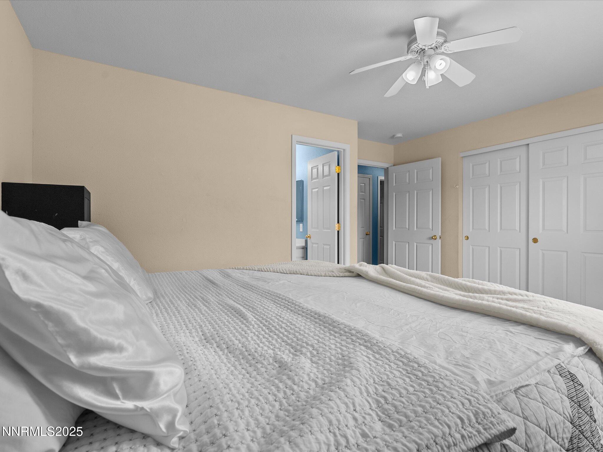 17795 Georgetown Drive Reno, NV 89508 - Photo 15 of 41 a bedroom with a large bed and a chandelier
