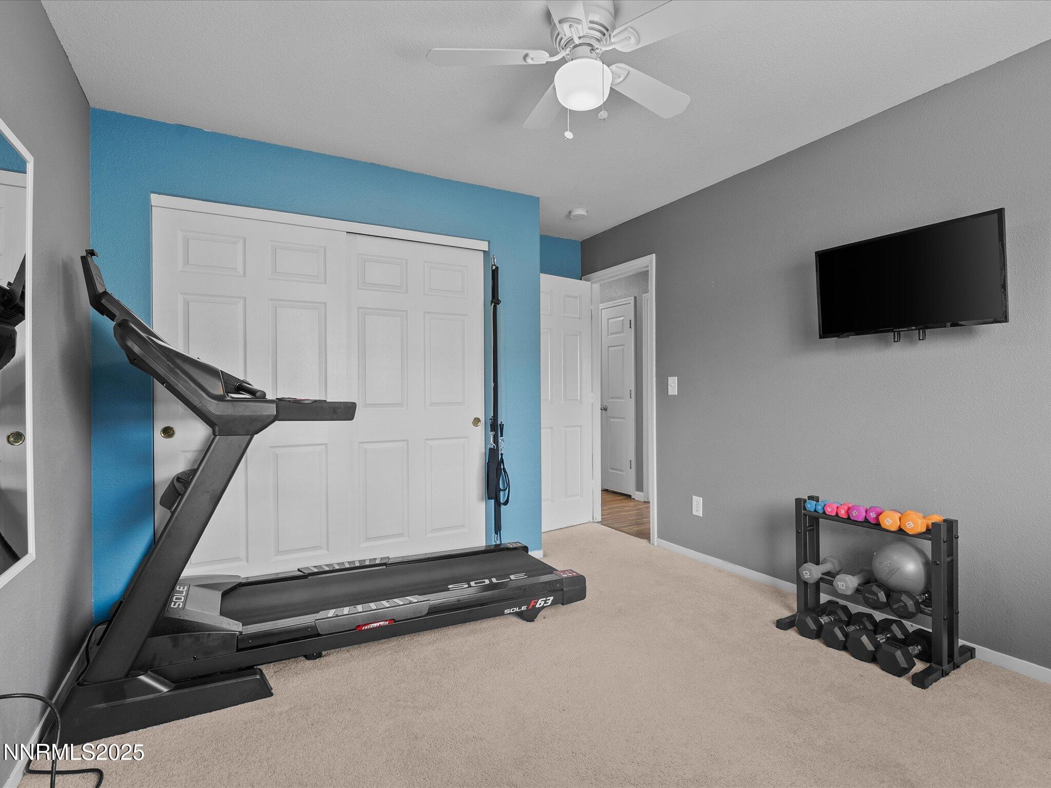 17795 Georgetown Drive Reno, NV 89508 - Photo 19 of 41 a room with gym equipment and a flat screen tv
