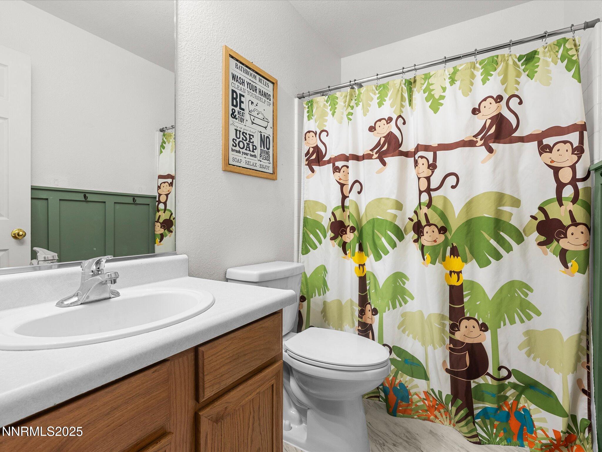 17795 Georgetown Drive Reno, NV 89508 - Photo 22 of 41 a bathroom with a toilet sink and mirror