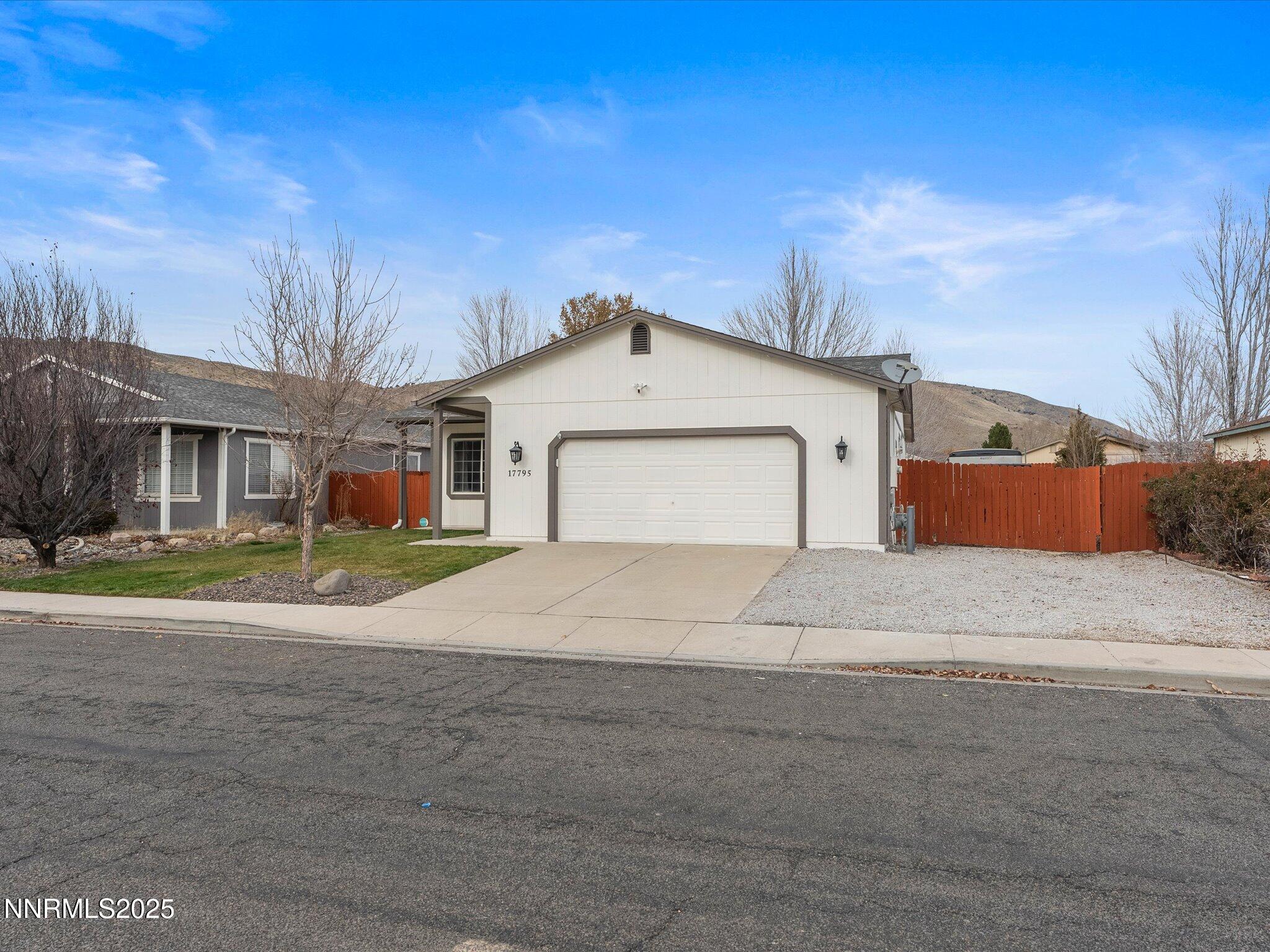 17795 Georgetown Drive Reno, NV 89508 - Photo 3 of 41 a front view of a house with a yard and garage